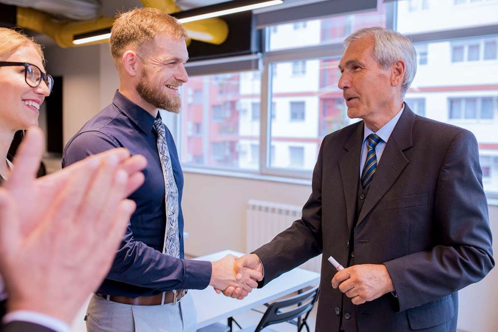 Two men shaking hands after completion of a Letter of Intent